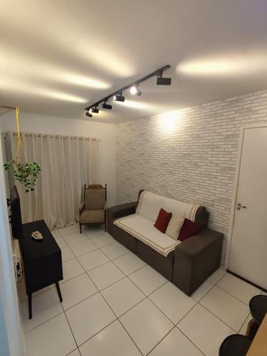 a living room with a couch and a chair at Cantinho da harmonia-Morada Nova in Petrolina