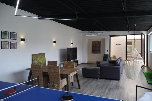 a living room with a ping pong table at SanRafa Home Office Suites in Mexico City