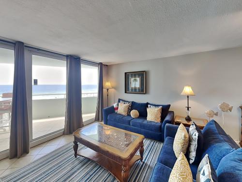 a living room with a blue couch and a table at Perdido Sun #410 in Perdido Key