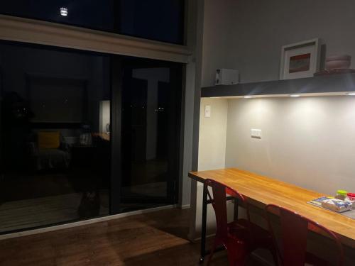 a kitchen with a wooden table and a counter top at Cabaña Julián Elías Gris in El Cerrillo