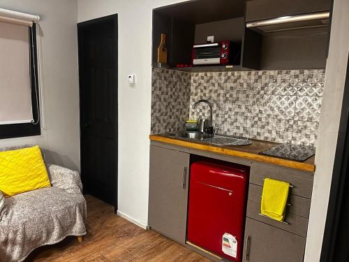 a small kitchen with a sink and a counter at Cabaña Julián Elías Gris in El Cerrillo