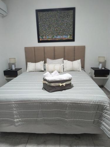 a bed with two pillows on top of it at DS confort in General Pico
