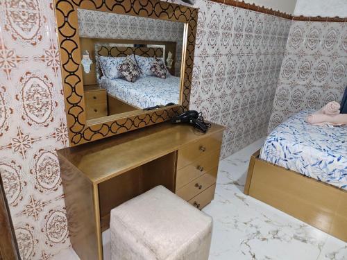 a bedroom with a mirror and a dresser and a bed at casa españa center of medina in Tangier