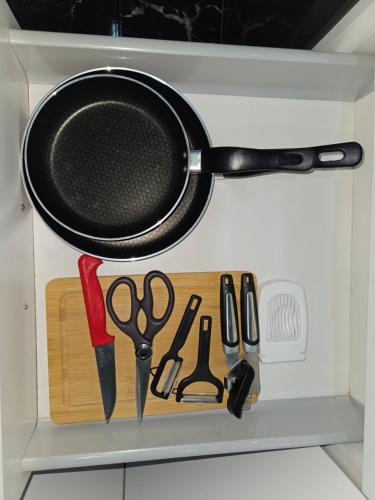 a drawer with a pan and other kitchen utensils at casa españa center of medina in Tangier