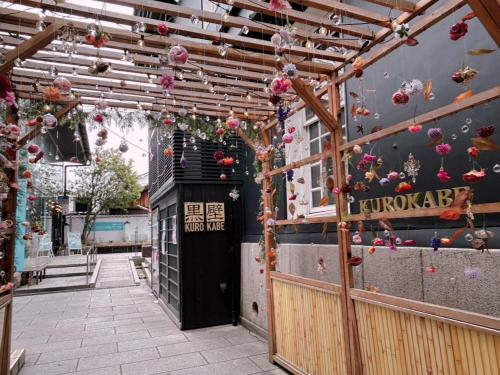 a building with a door with flowers on it at 長浜ゲストハウス楽市 in Nagahama