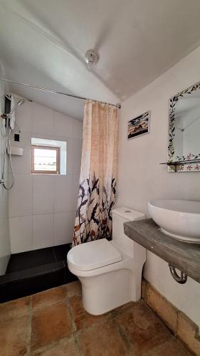 a bathroom with a toilet and a sink at ANCASH Caraz Miski Wasi in Caraz