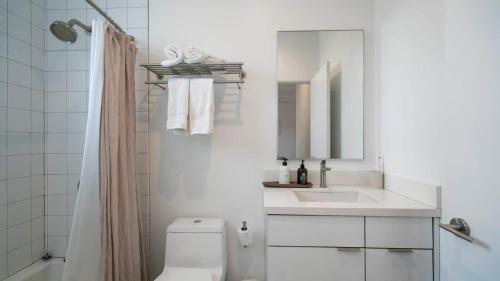 a white bathroom with a sink and a toilet at Desert Serenity Gateway To Joshua Tree in Joshua Tree