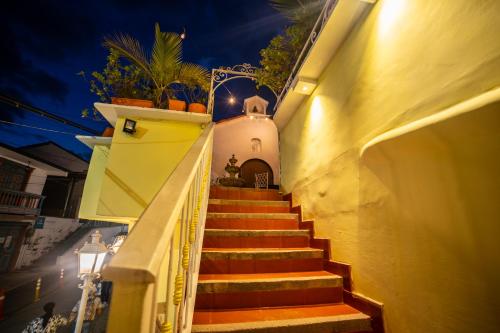 a stairway leading up to a building at night at Posada del Angel in Salento