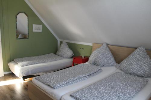 a bedroom with two beds and a mirror at Ferienwohnung Seeluft in Loissin