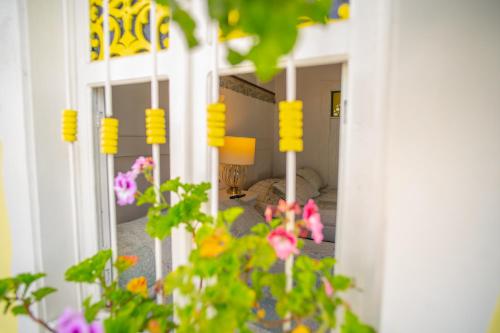 a view of a room with yellow flowers in the foreground at Posada del Angel in Salento