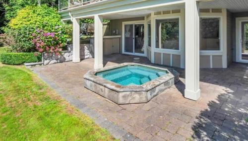 a swimming pool in the backyard of a house at Luxury 5BR Villa, Gym, Theater & Ocean Views in West Vancouver