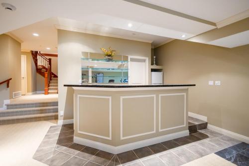a kitchen with a large island in a house at Luxury 5BR Villa, Gym, Theater & Ocean Views in West Vancouver