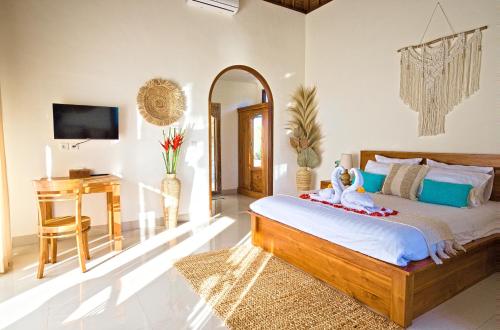 a bedroom with a bed with a desk and a mirror at Romantic Villa in Ubud Private Pooll and Rice Fields View in Ubud