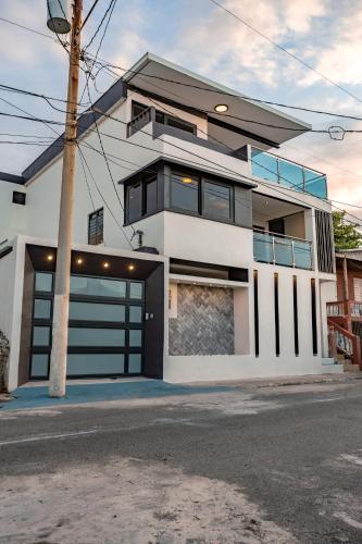 a white house with a garage at Zaturn Beach House in Arecibo