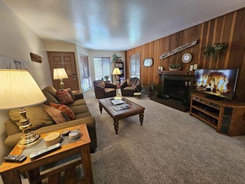 a living room with a couch and a fireplace at Pinenut Place home in Incline Village