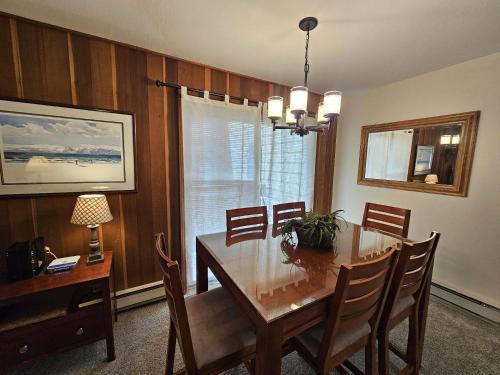 a dining room with a wooden table and chairs at Pinenut Place home in Incline Village