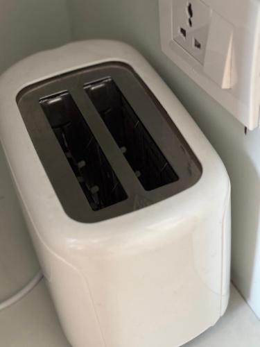 a white toaster sitting on top of a counter at Mums Homestay & Studio Apartments in Kathmandu