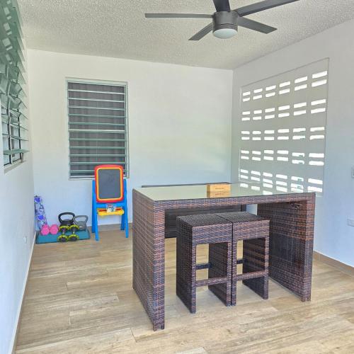 a living room with a table and a chair at Casa Colora in Naguabo