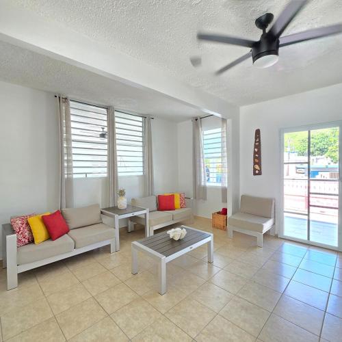 a living room with couches and a ceiling fan at Casa Colora in Naguabo