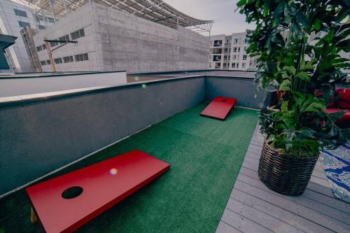 a balcony with two ping pong tables and a plant at Golden Triangle Townhome At Downtown Denver in Denver
