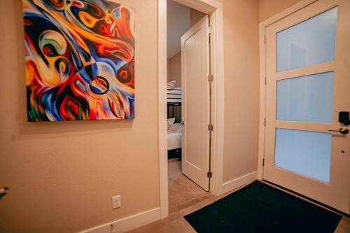 a door leading into a room with a painting on the wall at Golden Triangle Townhome At Downtown Denver in Denver