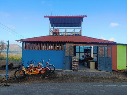 two bikes parked in front of a building with a tower at Hotel Yogiraj in Jāmb
