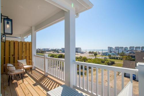 a balcony with a view of the ocean on a beach at SALTY DALTY & THREE BUOYS townhouse in Atlantic Beach