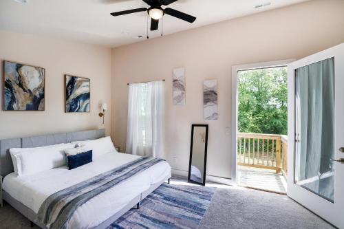 a bedroom with a bed and a ceiling fan at Stylish 3BR Home in CLT, Close to Downtown, Airport, WFH & Parking & Family Friendly & Business Ready in Charlotte