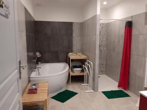 a bathroom with a tub and a red shower curtain at Maison de campagne rénovée avec jardin clos, proche Tours et grands sites du Val de Loire - FR-1-381-97 in Beaumont-la-Ronce