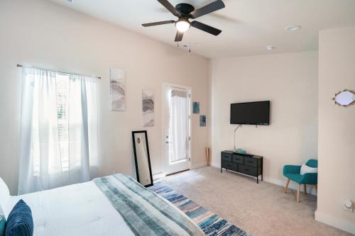 a bedroom with a bed and a ceiling fan at Stylish 3BR Home in CLT, Close to Downtown, Airport, WFH & Parking & Family Friendly & Business Ready in Charlotte