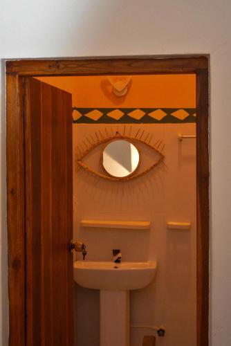 a bathroom with a sink and a mirror on the wall at Salty Alchemy in Arugam Bay