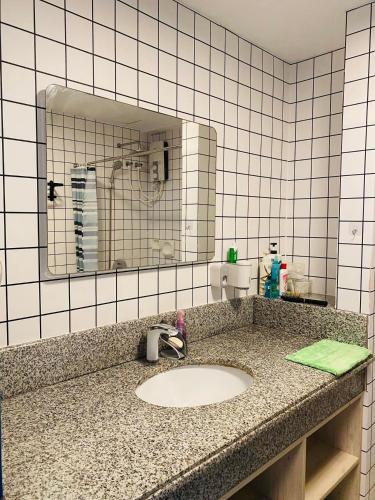 a bathroom counter with a sink and a mirror at Torre De Manila taft Tan38 in Manila