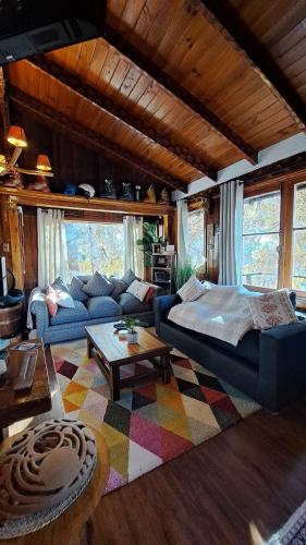a living room with a couch and a table at Hostal Boutique CUMBRES in Farellones
