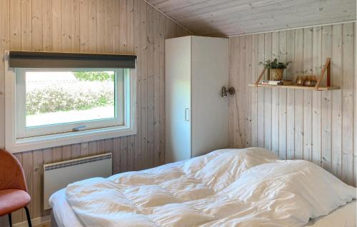 a bedroom with a bed with a window in it at Holiday Home Strandparken Xi in Otterup