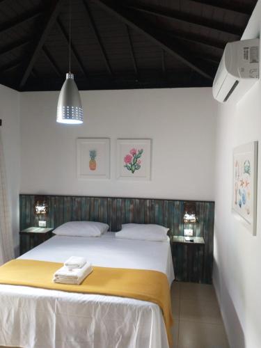 a bedroom with a bed with two towels on it at Villa Bangalu Exclusiva para Adultos in Porto De Galinhas