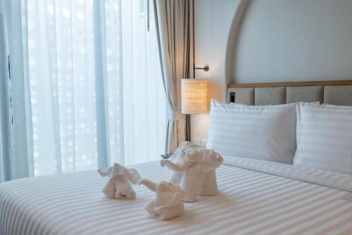 two stuffed animals on a bed in a hotel room at Phi Phi at Pier in Phi Phi Don