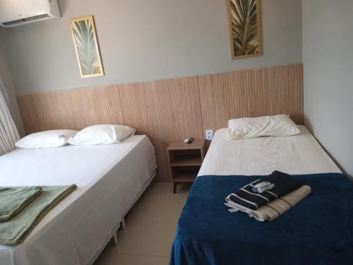 two beds sitting next to each other in a room at Zuppolini Garden Hotel in Bananeiras