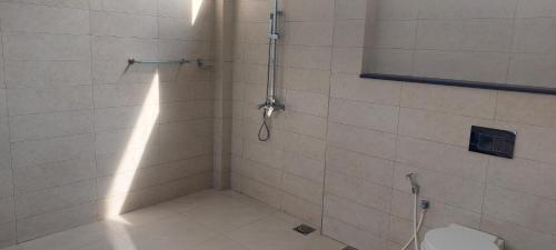 a bathroom with a shower with a toilet in it at L&S Villa in Wennawatta