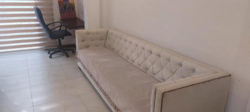 a couch sitting in a room next to a chair at L&S Villa in Wennawatta