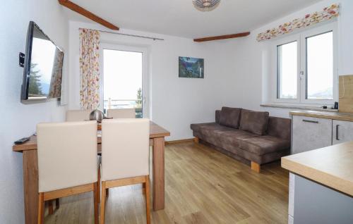 a kitchen and living room with a couch and a table at Ferienwohnung 45M2 in Sankt Koloman