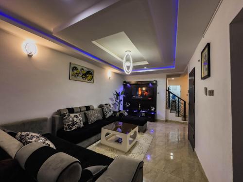 a living room with a couch and a fireplace at 2 Bedroom Apartment Lekki in Lekki