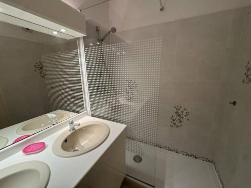 a bathroom with a sink and a mirror and a shower at Appartement avec grande terrasse et garage à Cavalaire-sur-Mer - FR-1-100-355 in Cavalaire-sur-Mer