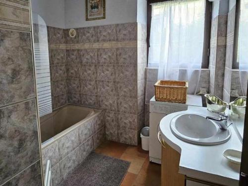 a bathroom with a tub and a sink and a shower at Gîte 8 personnes avec cheminée et SPA à Biron - FR-1-616-481 in Biron