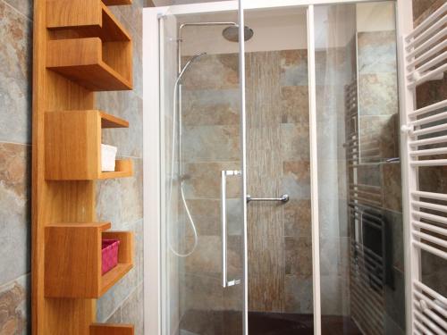 une douche avec une porte vitrée dans une salle de bain dans l'établissement Appartement T3 4 pers, Centre La Bourboule, Parking, WiFi, Chien admis - FR-1-608-293, à La Bourboule