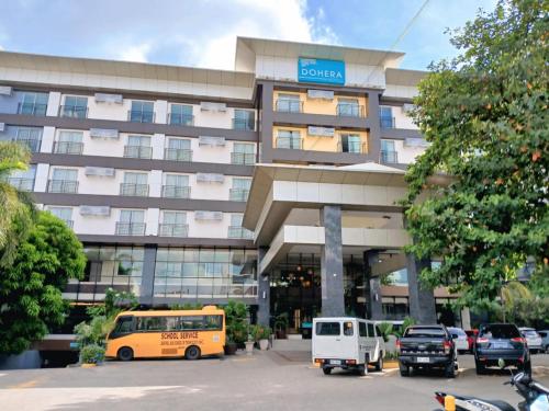 a building with a bus parked in front of it at Dohera Hotel in Cebu City