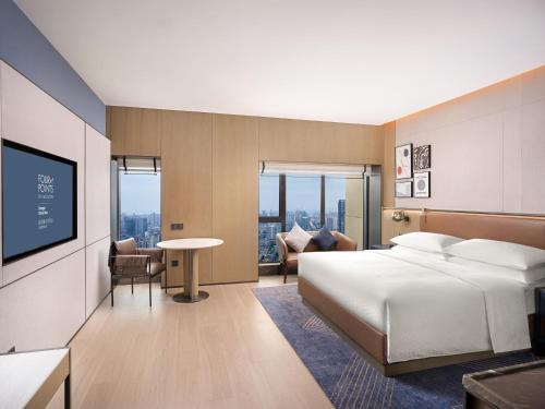 成都市にあるFour Points by Sheraton Chengdu, Chunxi Roadのベッドとテレビがあるホテルの部屋