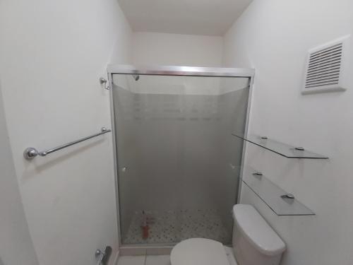 a white bathroom with a shower and a toilet at Casa con alberca compartida Netflix Disney Amazon TV in Hermosillo