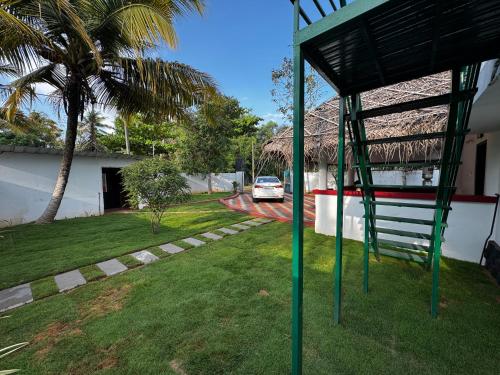 a view of a yard with a car parked in a house at Beach Heaven by Azure Heaven Holidays Pvt ltd in Mararikulam