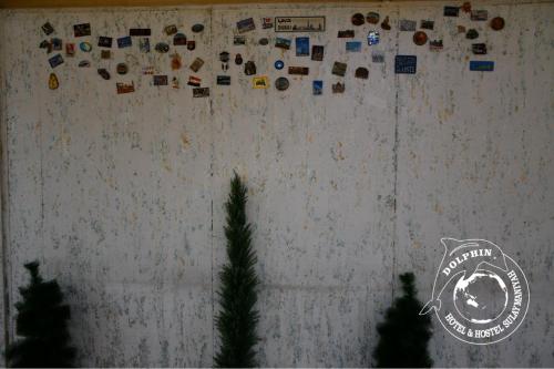 a wall with a wall with magnets on it at Dolphin Hotel & Hostel in As Sulaymānīyah