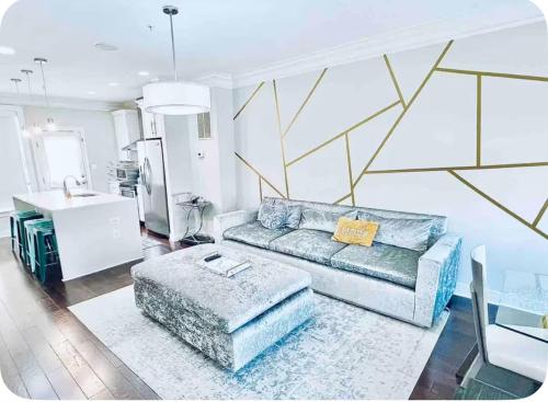 a living room with a couch and a table at Gorgeous Modern 4-Level 4BDR Home in Central Location Parking Included Free Cancellation in Washington, D.C.